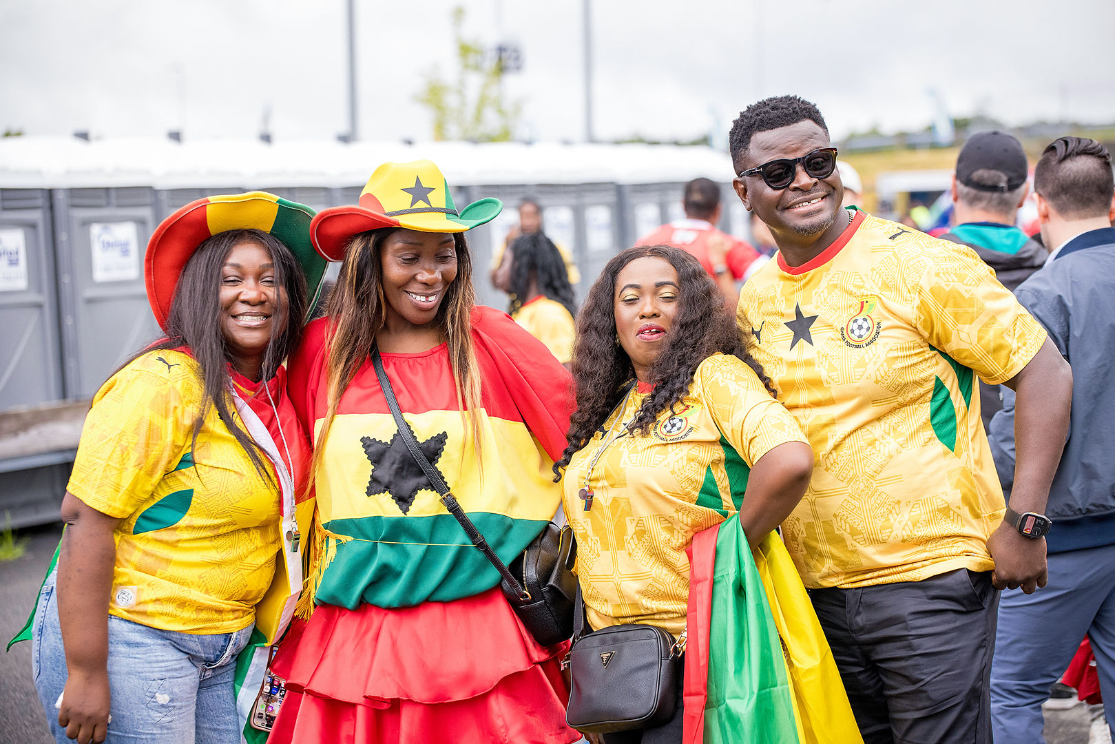 Ghana fans in vibrant outfits at a match-day tailgate