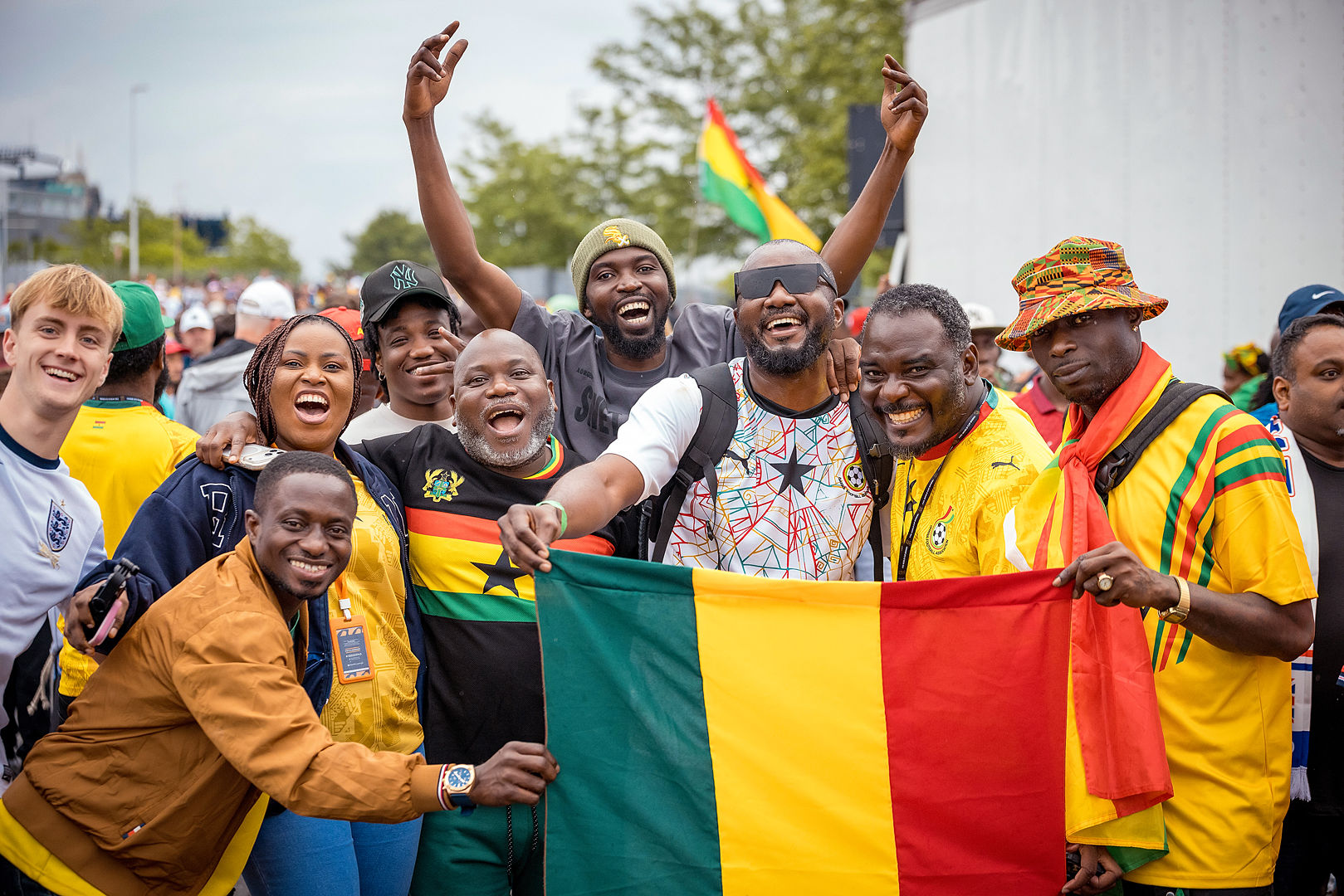 Ghana fans celebrating with a large national flag