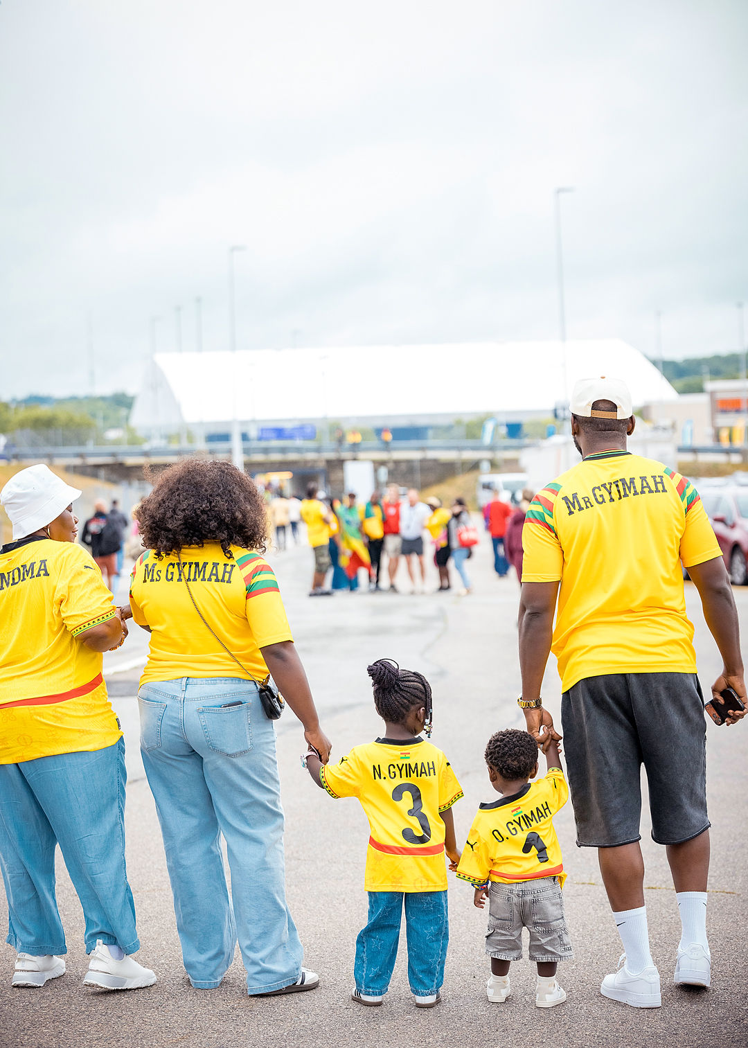 A family in custom Black Stars jerseys at the stadium